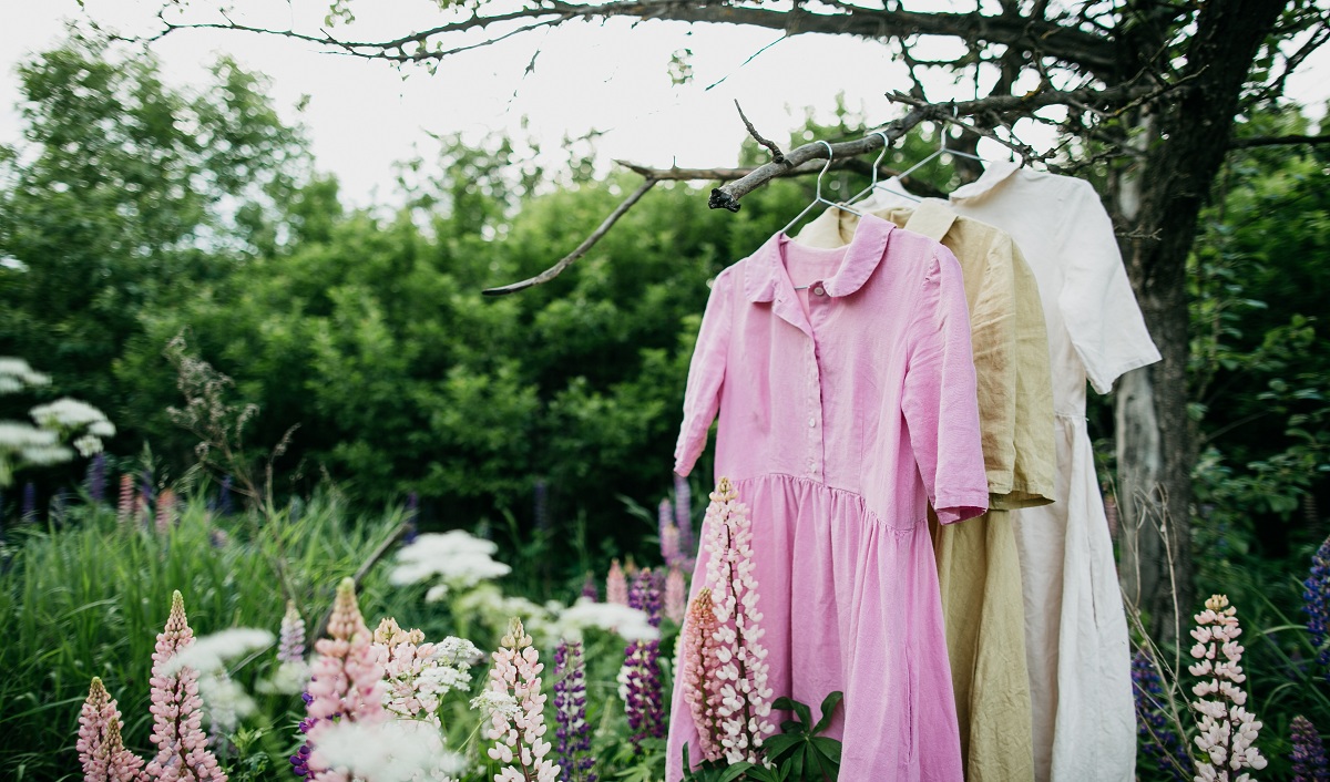Green Goddess: Embracing Sustainability in Every Stitch natural colored dresses hanging tree garden with lupine flowers